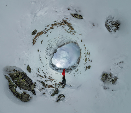 Spherical panorama of a lonely man standing in the mountains.の写真素材