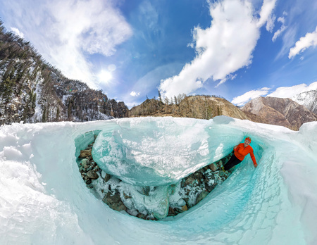 Female inside the crack in the ice glaciers Iceland. Wide-angle panorama.