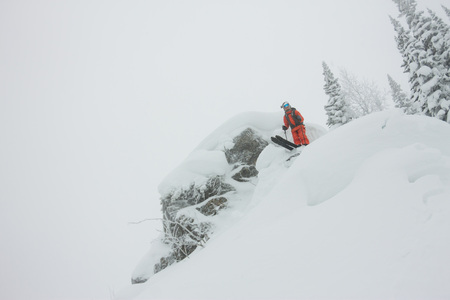 Man standing at top of ridge. Ski touring in mountains. Adventure winter freeride extreme sport.の写真素材