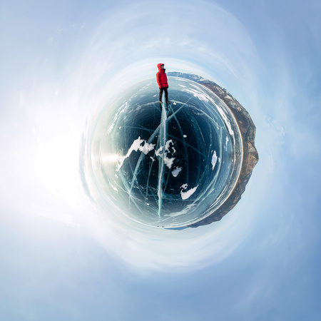Man on cracks on blue ice of Lake Baikal from Olkhon. Spherical 360 panorama little planet.の写真素材