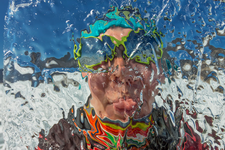 girl looks through a transparent ice floe on the lake baikal.の写真素材