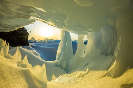 Transparent blue icicle ice cave in Lake Baikal.の写真素材