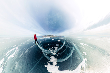 Panorama man stand on cracks on blue ice of Lake Baikal from Olkhon.の写真素材