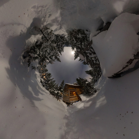 Panorama house chalet during a snowfall in the trees winter forest at night in the moonlight. Tiny planet 360 panoramaの写真素材