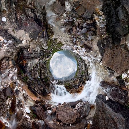 Mountain waterfall stream in misty rainy weather in the valley. Tiny little planet 360の写真素材