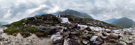 Mountain waterfall stream in misty rainy weather in the valley flowers. Cylindrical panorama 360の写真素材