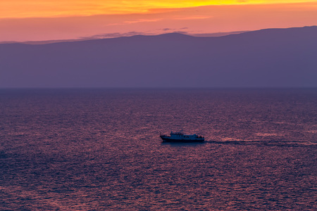 ship sails on a background of purple sunset sky on the waves of Lake Baikal from Olkhonの写真素材