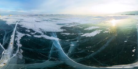 Ice crack at sunset in the ice of Lake Baikal at the on Olkhon Island. Cylindrical panorama 360.の写真素材