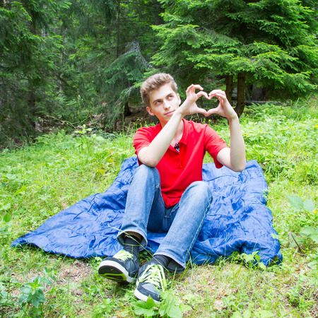 Young man showing heart signの写真素材