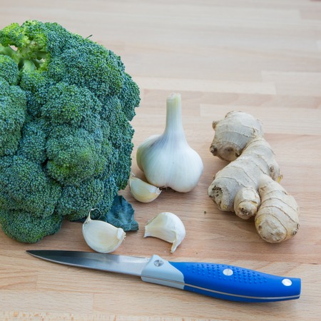 Broccoli with garlic and knife on the wooden table still lifeの写真素材