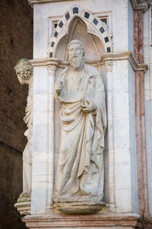Architectural details of a the nice Tower Torre del Mangia in Siena Italyの写真素材