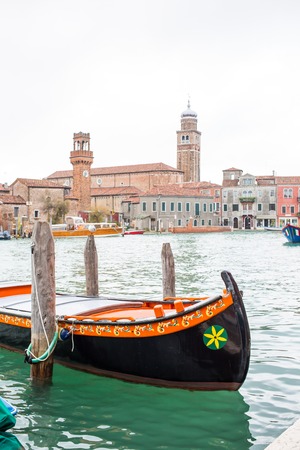 Romantic Venetian scenery with gondola and Venice buildingsの写真素材