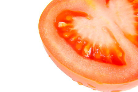 Slice of tomato isolated on whiteの写真素材