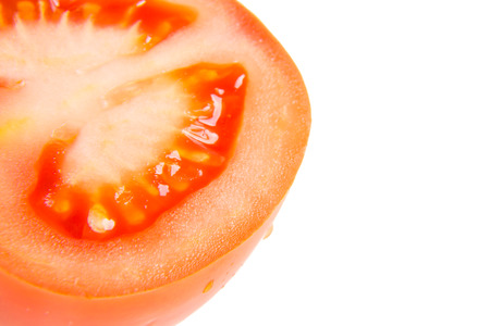 Slice of tomato isolated on whiteの写真素材