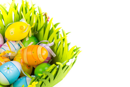 Green grass box with Easter eggs on the white backgroundの写真素材