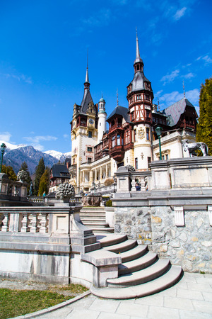 Spring view of Peles Castle with snow Bucegi Mountains in the background.のeditorial素材