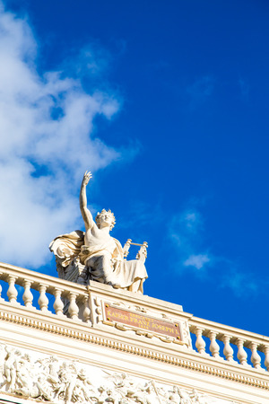 Blue cloudy sky with the statues of Austrian National Theater, K.K. Theater an der Burg, Vienna, Austria. Place for textの写真素材