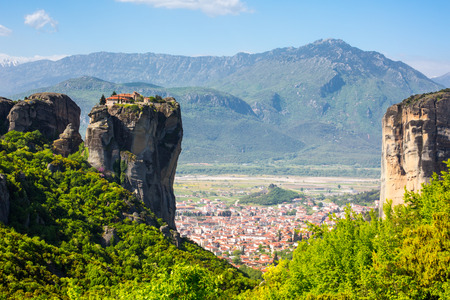 Aerial view of monastery at Meteora cliff  in Greece and traditional greek Kalambaka town with red...