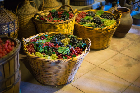 Baskets with the colorful Grapes in old wine cellar in monastery in Meteora, Greeceの写真素材