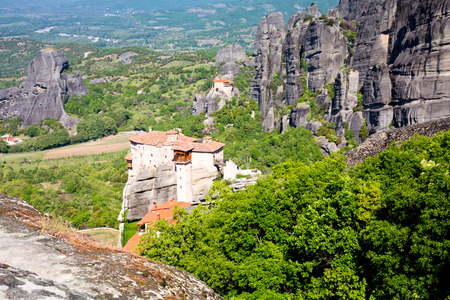 Panoramic view of Meteora monasteries on the high rocks and road in the mountains at spring time, Greeceの写真素材