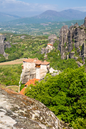 Panoramic view of Meteora monasteries on the high rocks and road in the mountains at spring time, Greeceの写真素材