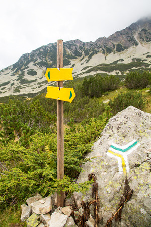 Signpost to different directions and touristic at the mountainsの写真素材