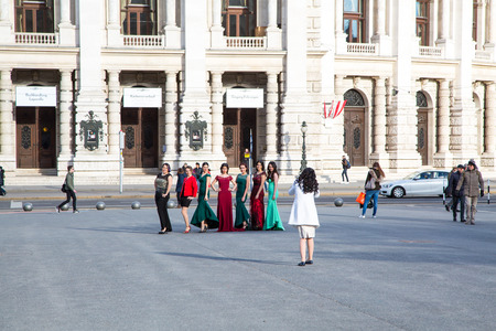 Vienna, Austria - April 3, 2015: Group of pretty ladies in colorful dresses posing to photographer near Burgtheater, Viennaのeditorial素材