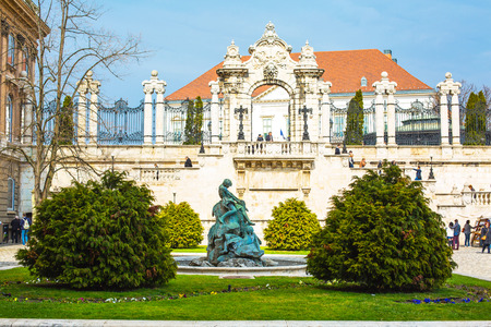 Budapest, Hungary - March 29, 2015: Buda Castle Palace entrance gate, statue and tourists walking aroundのeditorial素材