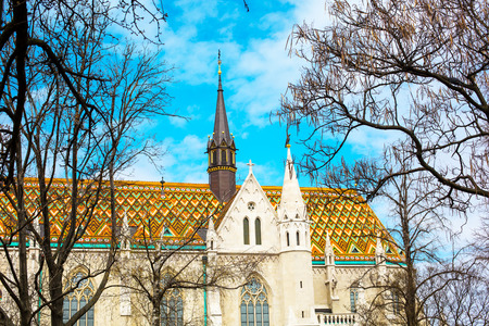 Part of the roof and towers of Matthias Church in Budapest Hungary on the blue sky backgroundの写真素材