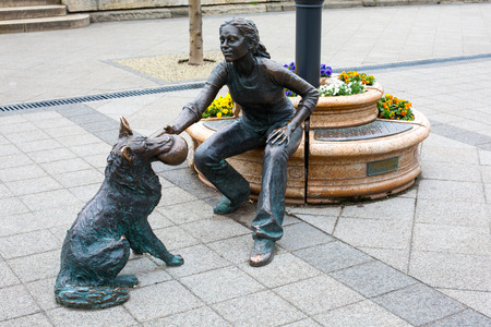 Budapest, Hungary - March 31, 2015: Statue sculpture bronze of girl with dog with ball on Danube promenade, Budapest , Hungary. Sculpted by Raffay Davidのeditorial素材
