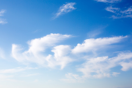 Idyllic white fluffy clouds in the blue skyの写真素材