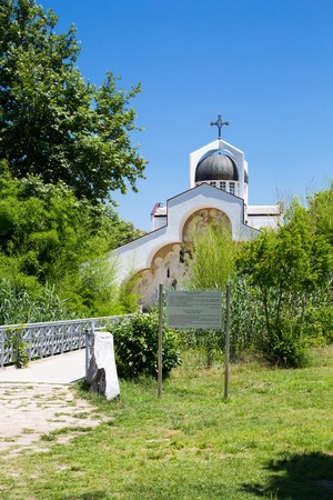 Front view of St Petka of Bulgaria, Baba Vanga's church in Rupite, Bulgaria and the path to it through the bridge and green plantsの写真素材