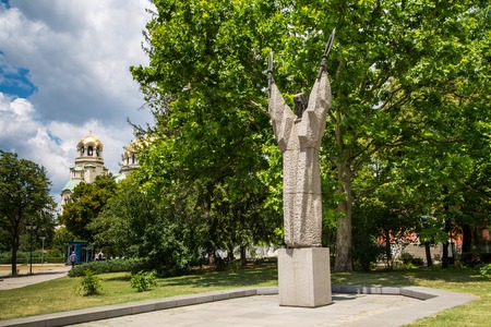 Sofia, Bulgaria - June 4, 2015: Statue of Kliment Ohridski in the center of Sofia, Bulgaria and Golden dome of St. Alexander Nevsky Cathedral on the backgroundのeditorial素材
