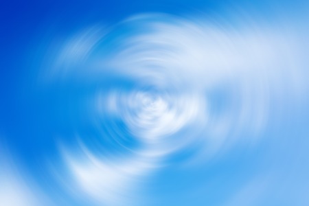 Background with spin radial blur effect of vibrant  blue cloudy skyの写真素材