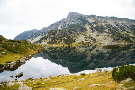 Popovo lake at Bezbog region in Bulgaria and mountains reflectionの写真素材