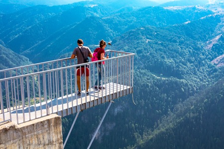 Rhodope, Bulgaria - July 29, 2015: People taking photo at panoramic mountain viewpoint Eagle eye, Orlovo Oko in Rhodope or Rodopi mountains in Bulgaria. The platform is mounted on the edge of the cliffs.のeditorial素材