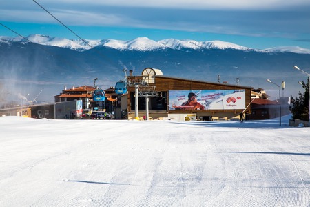 Bansko, Bulgaria - February 19, 2015: Bansko ski station, cable car lift in Bansko, Bulgaria. White snow field and snow peaks of the mountainsのeditorial素材