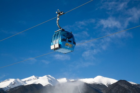 Bansko, Bulgaria - February 19, 2015: Cable car cabin and snow peaks of the mountainsのeditorial素材