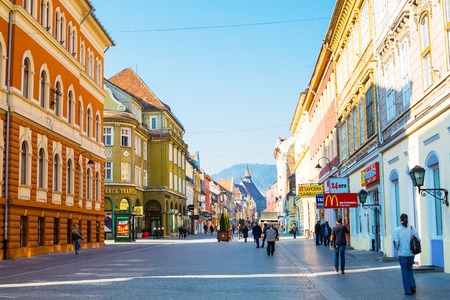 Brasov, Romania - March 24, 2015: People at the pedestrian street Republicii at downtown of Brasov, Transylvania, Romania. Black church is seen a distance away.のeditorial素材