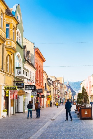 Brasov, Romania - March 24, 2015: People at the pedestrian street Republicii at downtown of Brasov, Transylvania, Romania. Black church is seen a distance away.のeditorial素材