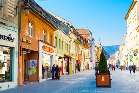 Brasov, Romania - March 24, 2015: People at the pedestrian street Republicii at downtown of Brasov, Transylvania, Romania. Black church is seen a distance away.のeditorial素材