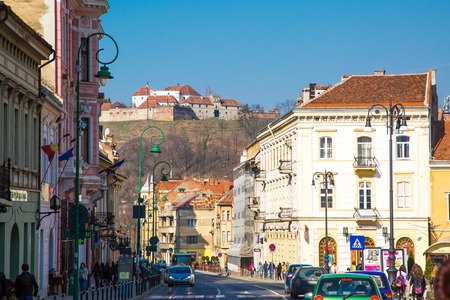 Brasov, Romania - March 24, 2015:  Street view and famous medieval fortress citadel in Rupea, Brasov, Transylvania, Romania. View from the city to the hillのeditorial素材