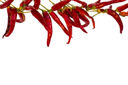 Bundle of hot chili peppers on the top isolated on white background