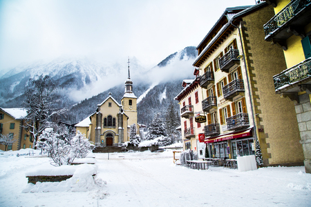 Chamonix, France - January , 30, 2015: Church in Chamonix town, France, French Alps  in winter, part of the street  and mountains behindのeditorial素材