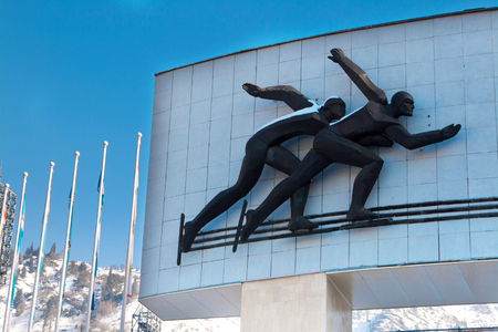 Almaty, Kazakhstan - March, 2, 2014: Ice skaters at Famous skating rink Medeo in Almaty, Kazakhstan and mountains at the backgroundのeditorial素材