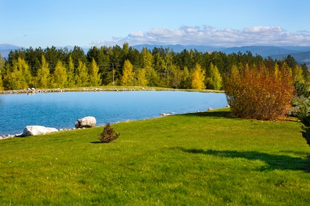 Panorama of Beautiful autumn Landscape view of the lake, colorful trees and mountains backgroundの写真素材