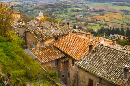 Colorful Tuscany panoramic landscape with old traditional houses roofs, cypress, vineyards,  Italyの写真素材