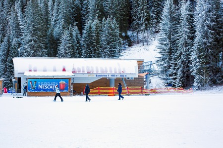 Bansko, Bulgaria - December, 12, 2015: Bansko Banderitza ski lift at Banderishka polyana, Bulgaria, pistes and mountain with pine trees, ski slope, peopleのeditorial素材