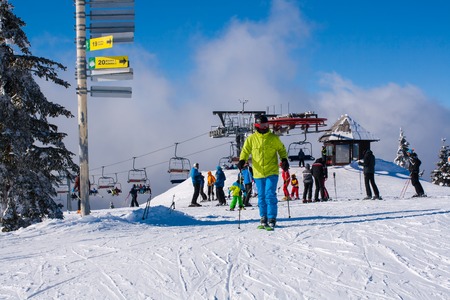 Kopaonik, Serbia - January 22, 2016: Ski resort Kopaonik, Serbia, ski lift, ski slope, people skiing down from the lift and skiingのeditorial素材