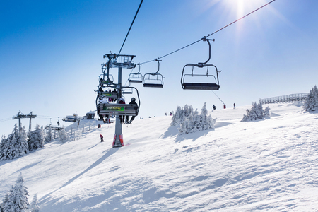 Kopaonik, Serbia - January 22, 2016: Ski resort Kopaonik, Serbia, ski slope, people on the ski lift, skiers on the piste, sun raysのeditorial素材